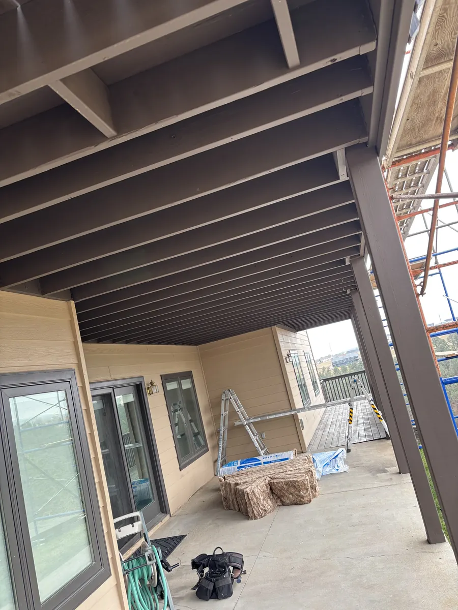 Covered patio under construction with steel supports