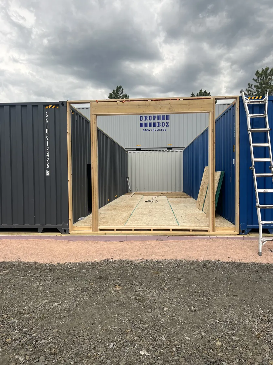 Shipping container with custom framed opening under construction