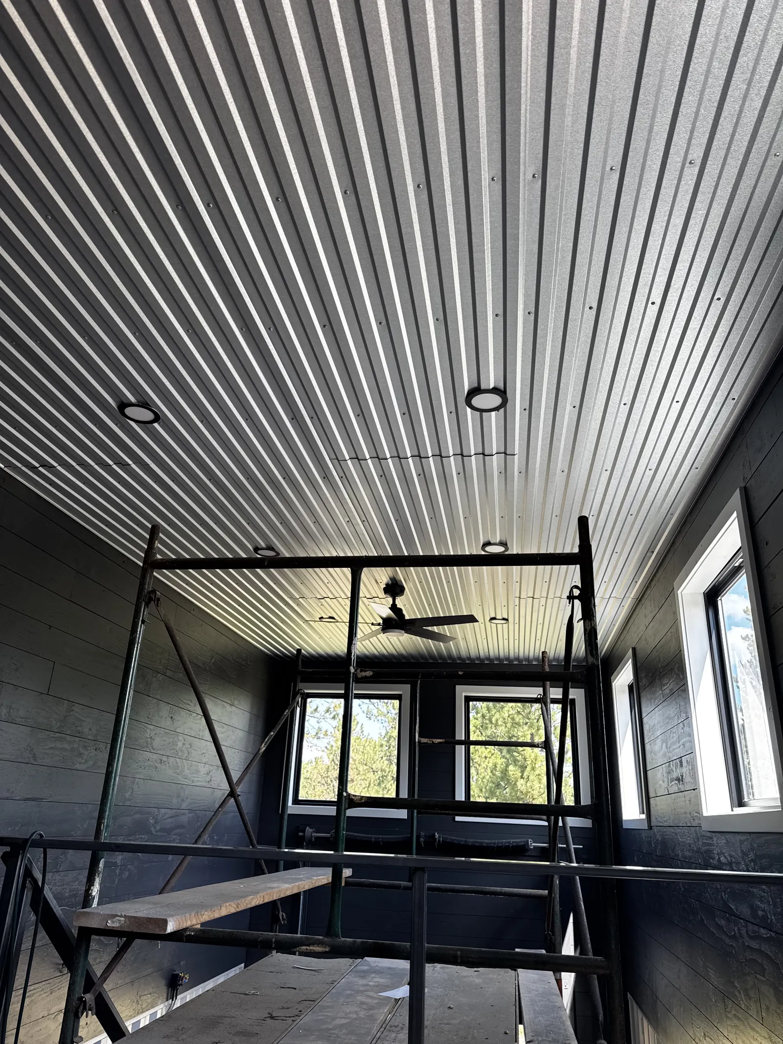 Dark-painted interior with finished metal ceiling by Black Hills Property Solutions